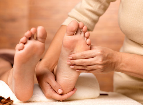 Massage of human foot in spa salon