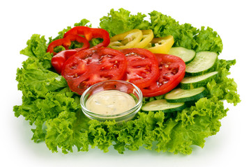Chopped vegetables and sauce on plate isolated on white