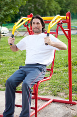 Man is  in  the gym outdoors