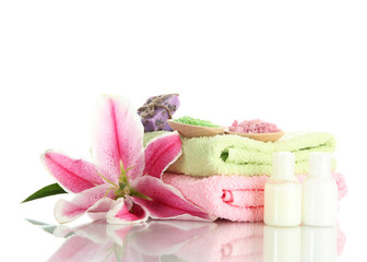 towels with lily, aroma oil, soap and sea salt isolated on