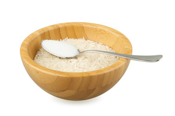 bamboo bowl with rice and steel spoon with salt