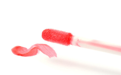 beautiful lip gloss smear with brush, isolated on white