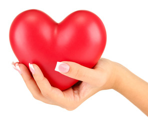 Obraz na płótnie Canvas Red heart in woman's hand, on white background close-up