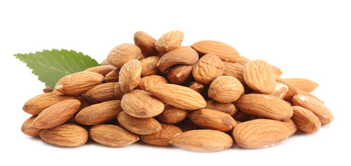 tasty almonds nuts with leaves, isolated on white