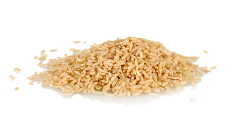 brown rice uncooked in a heap isolated on a white background