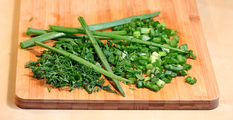 Greens: onion, parsley and dill on the chopping board