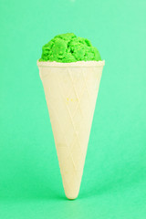 Scoop of the kiwi ice cream in the waffle cone