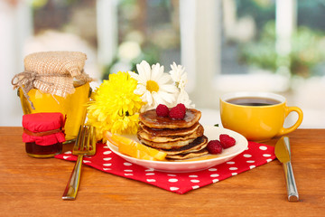 delicious sweet pancakes on bright background