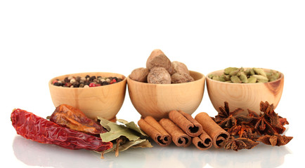 Nutmeg and other spices isolated on white
