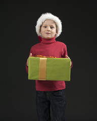 little boy with christmas hat and gift box