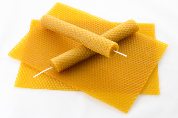 two Candle made of beeswax on honeycomb - background