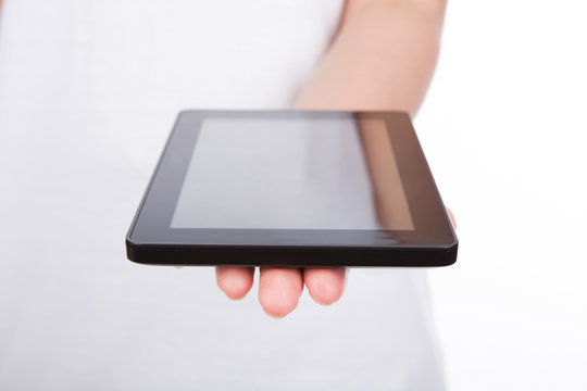 Woman hand using a touch screen device against white background