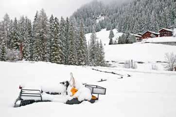 Snowmobile covered with snow