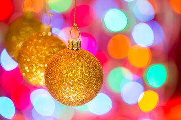 Golden christmas ball on bokeh background