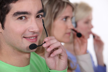 Young people with telephone headsets