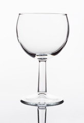 Single empty wineglass on a white background