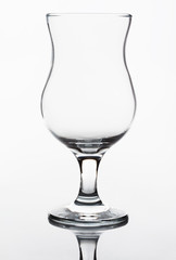 Single empty wineglass on a white background