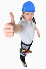 An austere tradesman giving the thumb's up
