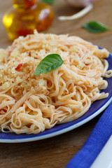 Homemade pasta with green basil and tomato sauce