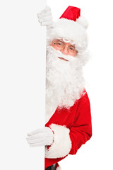 Smiling Santa Claus posing behind a blank panel