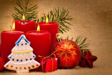 Four red candles with Christmas balls. 