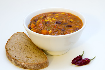 Chilli con carne in a bowl with bread