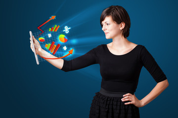 Young woman looking at modern tablet with abstract lights and va
