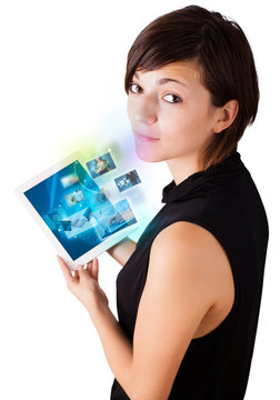 Young woman browsing pictures on modern tablet
