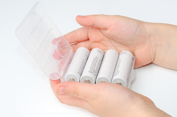 Case with white batteries in hands