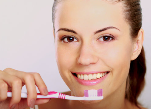 Woman with great teeth holding tooth-brush