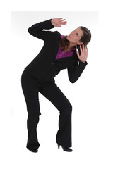 A businesswoman afraid of something falling from the ceiling.