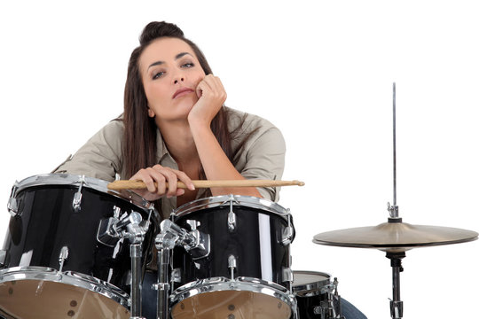 Woman sat behind drum kit