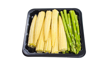 Asparagus and baby corn in black container isolated on white bac