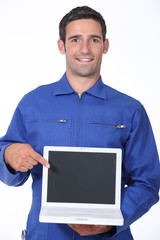 Manual worker pointing to laptop