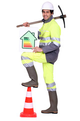 Construction worker holding a pickaxe and an energy rating