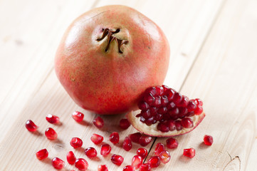 Pomegranate and grains on wooden boards, horizontal shot