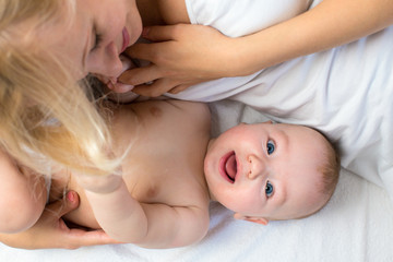 happy mother lying with baby boy