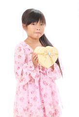 Little girl holding a heart shaped gift box