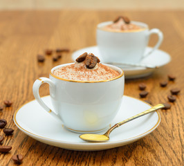Dessert coffee in a small cup on a brown table