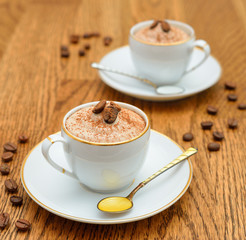 Dessert coffee in a small cup on a brown table