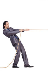 Businessman pulling rope on white