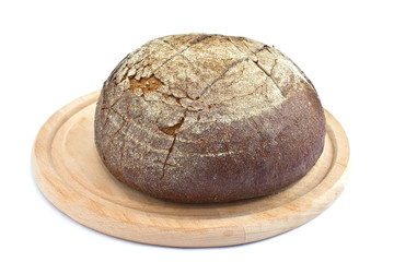 Fresh homemade  loaf of bread on board  isolated on white