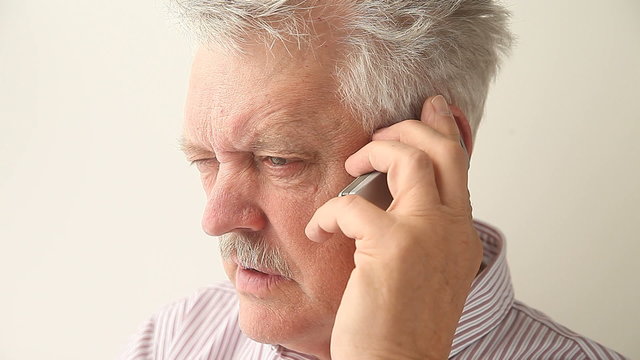 Angry Senior Man On Mobile Phone