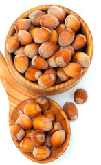 hazelnuts in a wooden spoon and bowl