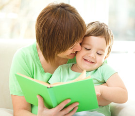 Fototapeta na wymiar Mother is reading book for her son
