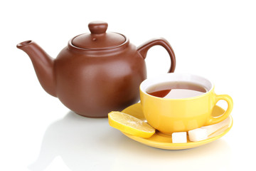 Yellow cup with saucer and teapot isolated on white