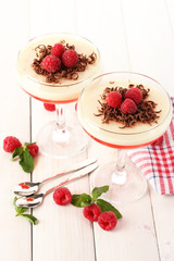 fruit jelly with berries in glasses on wooden table