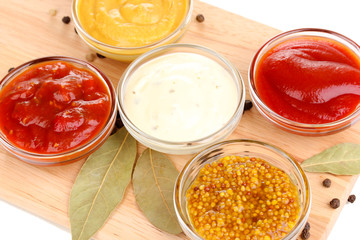 various sauces on chopping board close-up