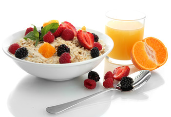 tasty oatmeal with berries and glass of juice, isolated on