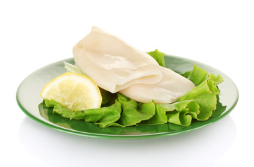 boiled squids with lettuce and lemon in the plate isolated